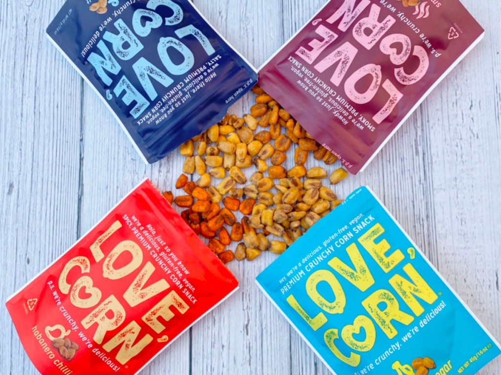 4 bags of love corn snacks open with corn snacks laying between them 