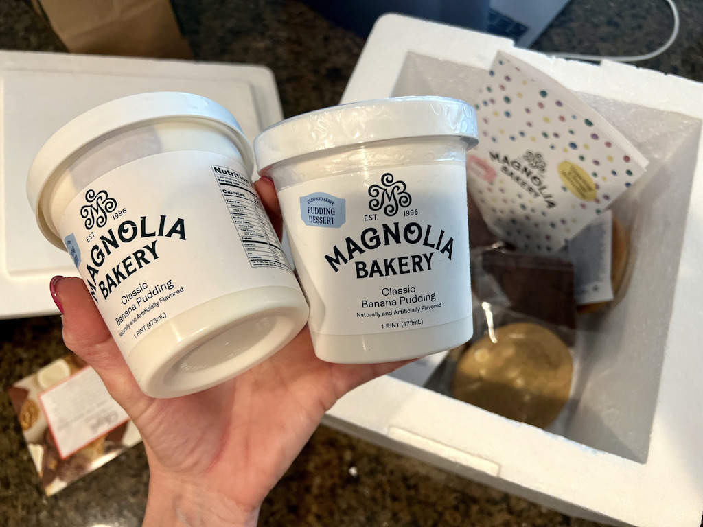 holding Magnolia Bakery banana puddings 