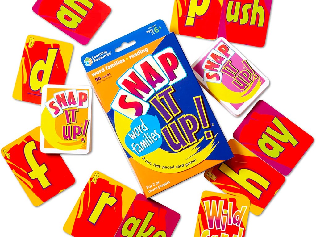 snap it up card game box with cards laying around it