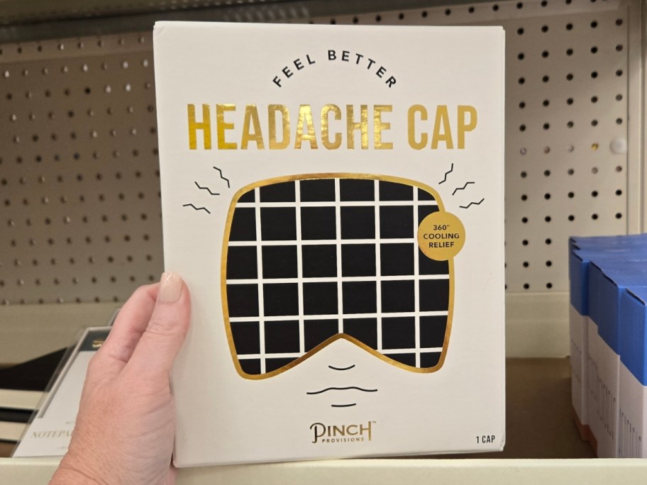 hand holding headache cap in store