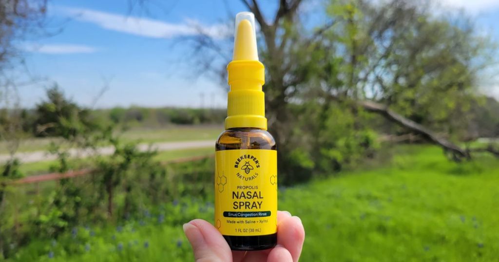 hand holding Beekeepers nasal spray outdoors