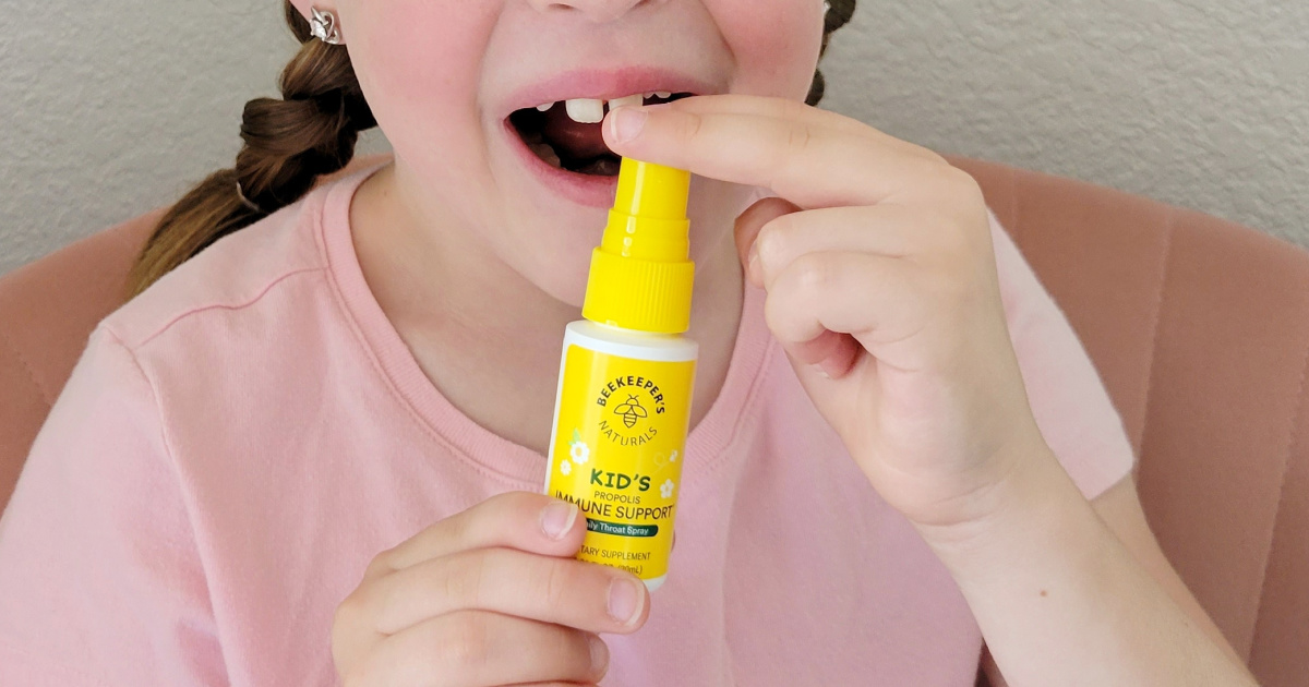 girl using throat spray