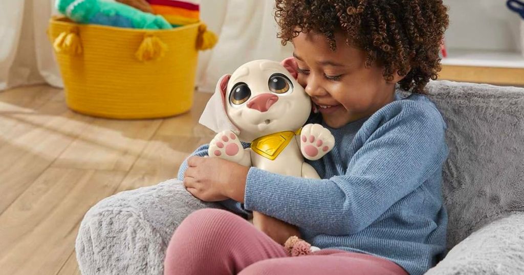 a little boy hugging a DC League of Super-Pets Baby Krypto Poseable Toy