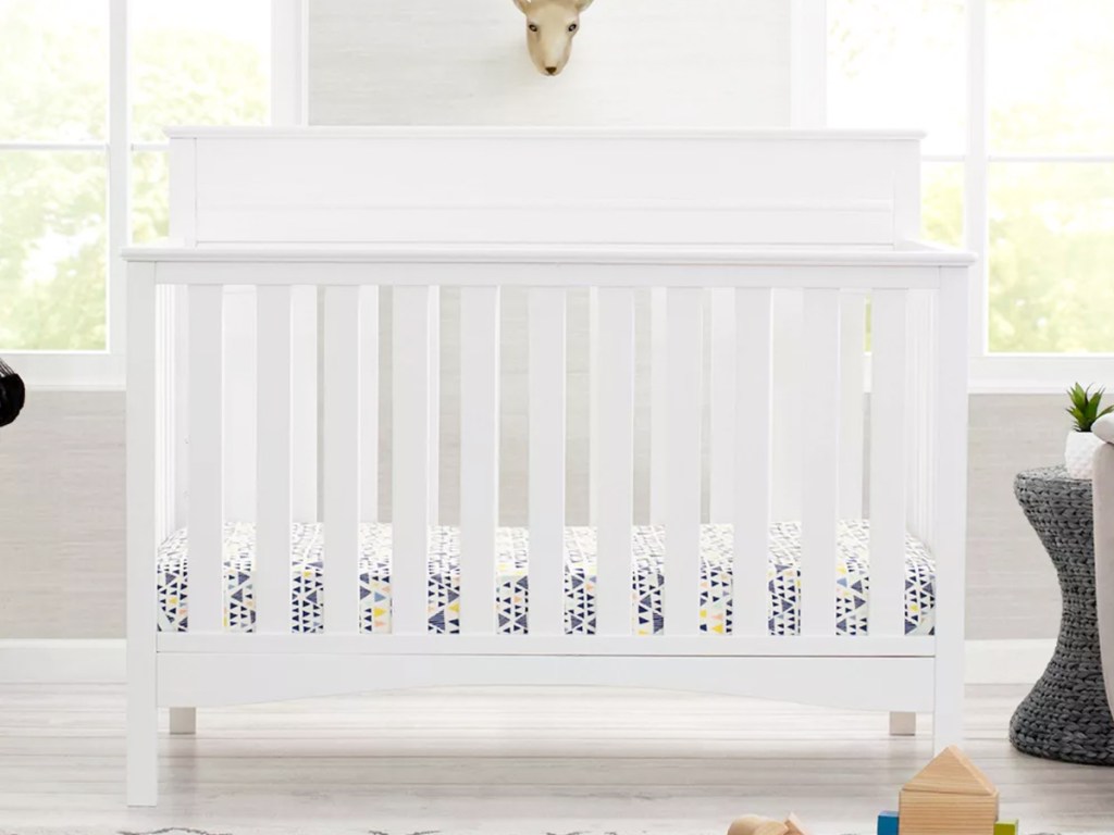 Nursery with a white crib in the center