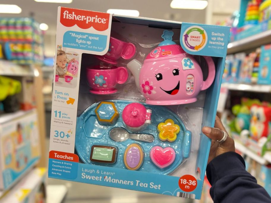 a womans hand holding an interactive tea set