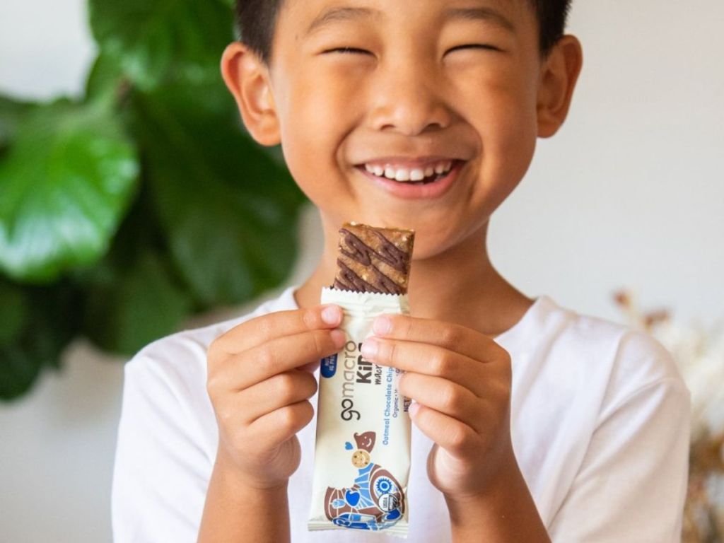 Kid holding a GoMacro Kids Bar