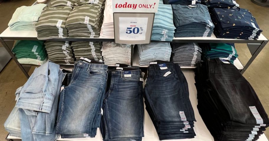 Table of Old Navy Jeans with a 50% off sign