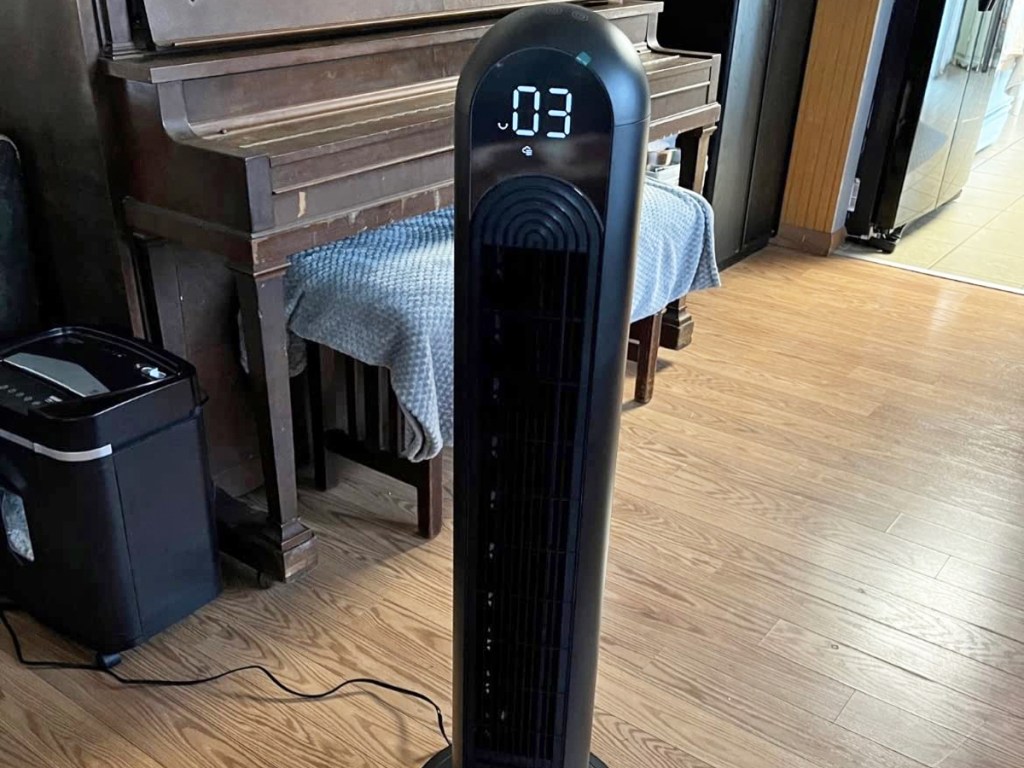 black tower fan near a piano