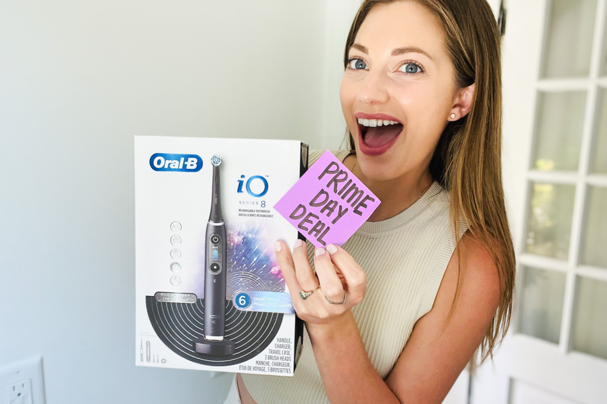 Woman holding an Oral B electric toothbrush from Amazon