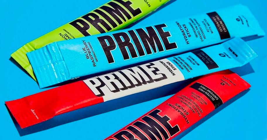 Different flavors of prime drink mix packets on blue background