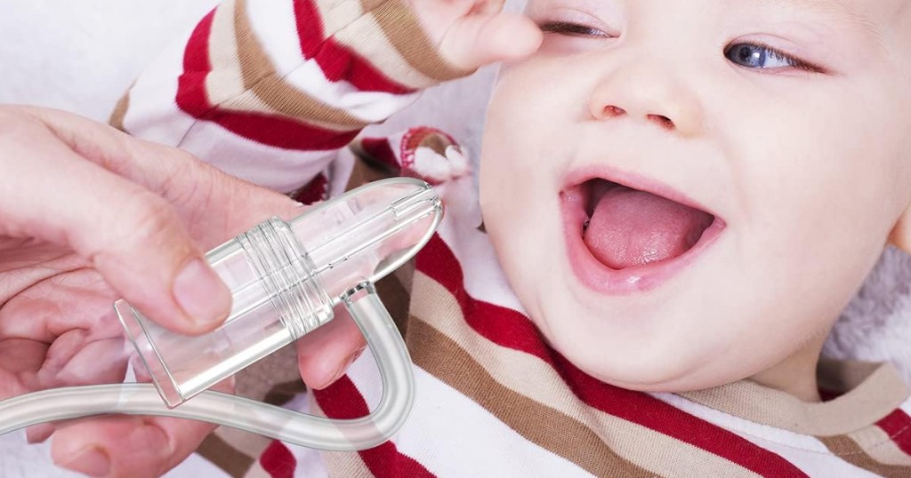 holding Pumpinose Nasal Aspirator near baby's nose