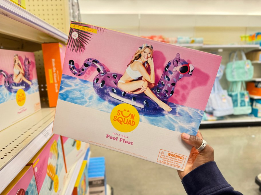 Hand holding up a Purple Leopard Pool Float