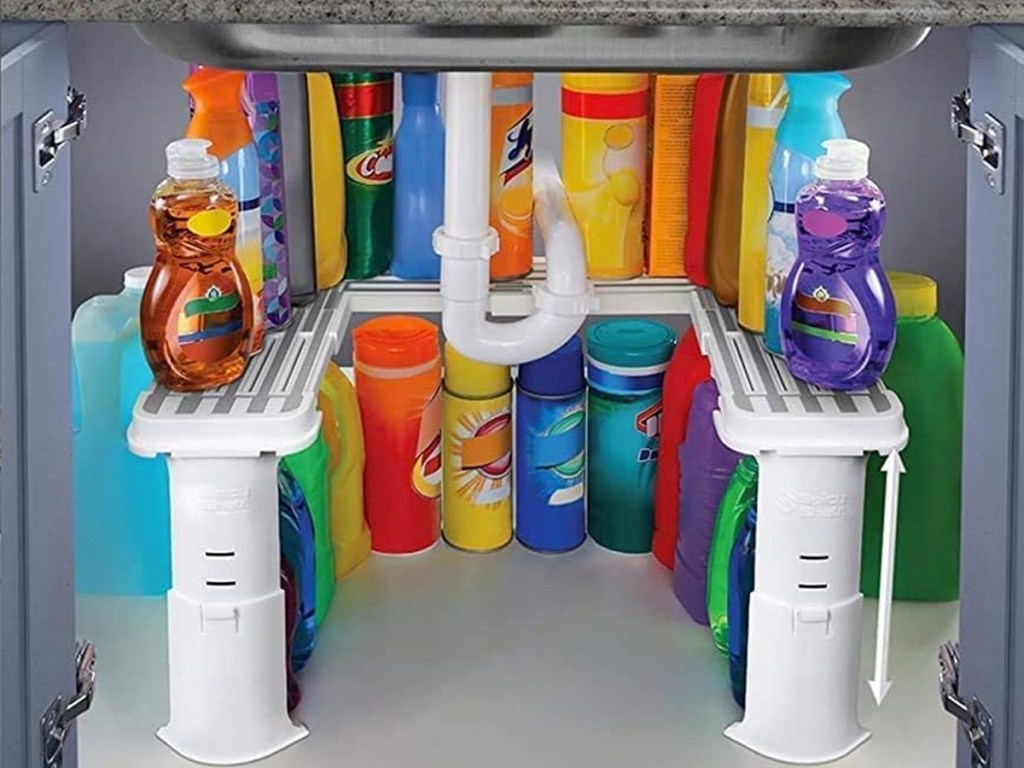 cleaning products on a white organizer in cabinet under kitchen sink