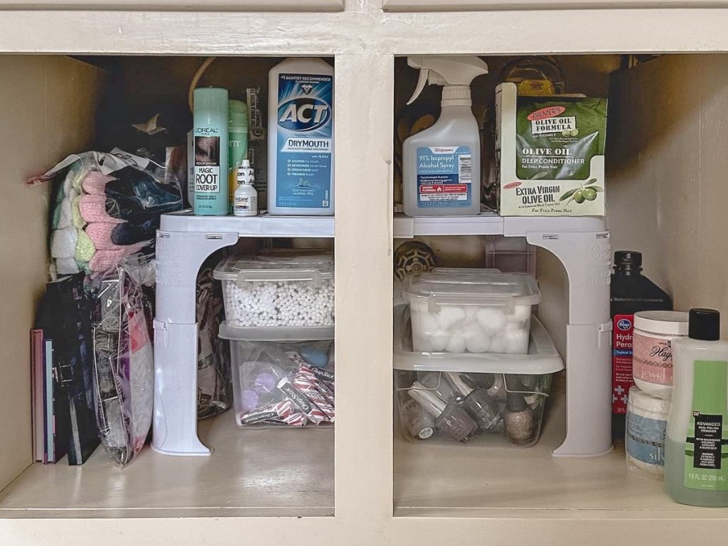 personal care products on a white organizer in cabinet under bathroom sink