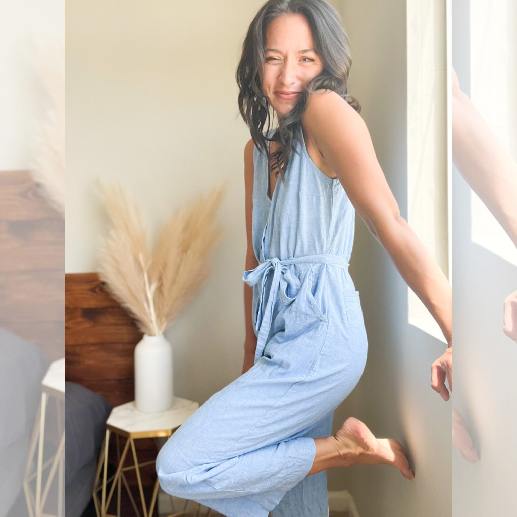 woman near window in blue denim jumpsuit