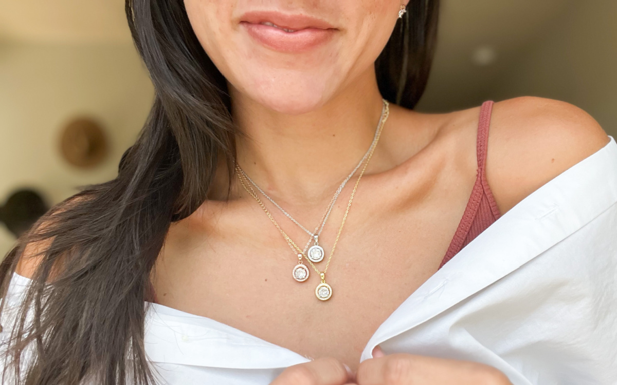 woman wearing three pendant necklaces