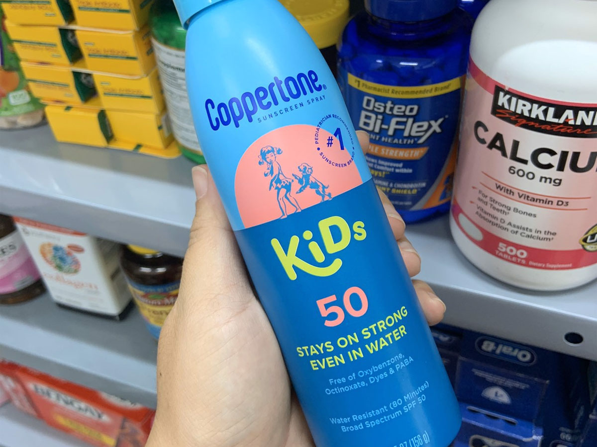 hand holding coppertone 50 spray