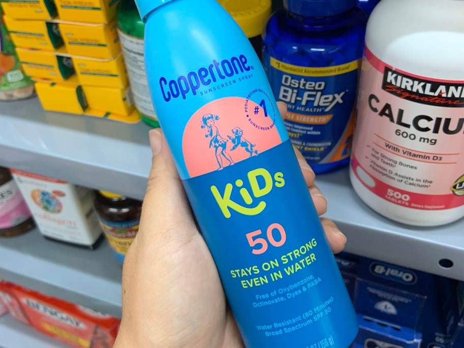 hand holding coppertone 50 spray