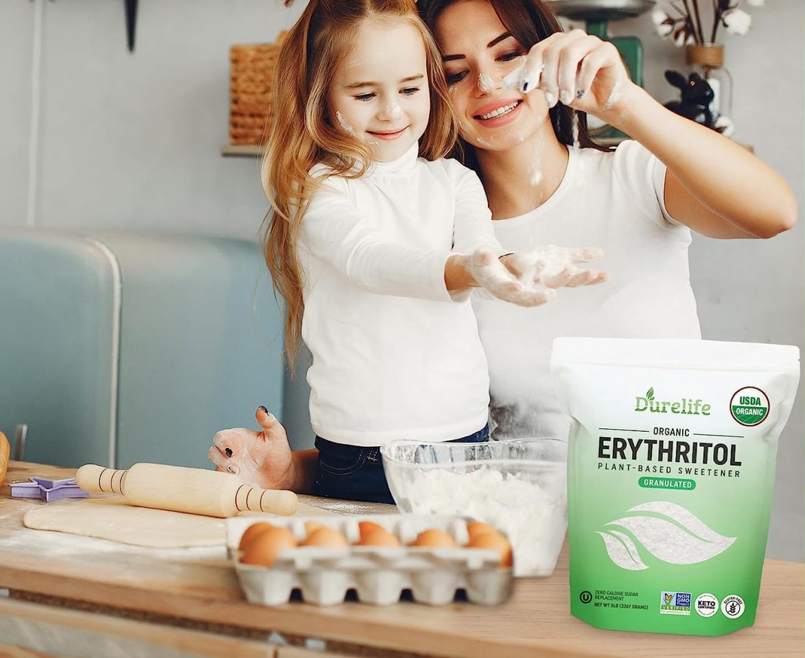 mother and daughter baking next to bag of sweetener