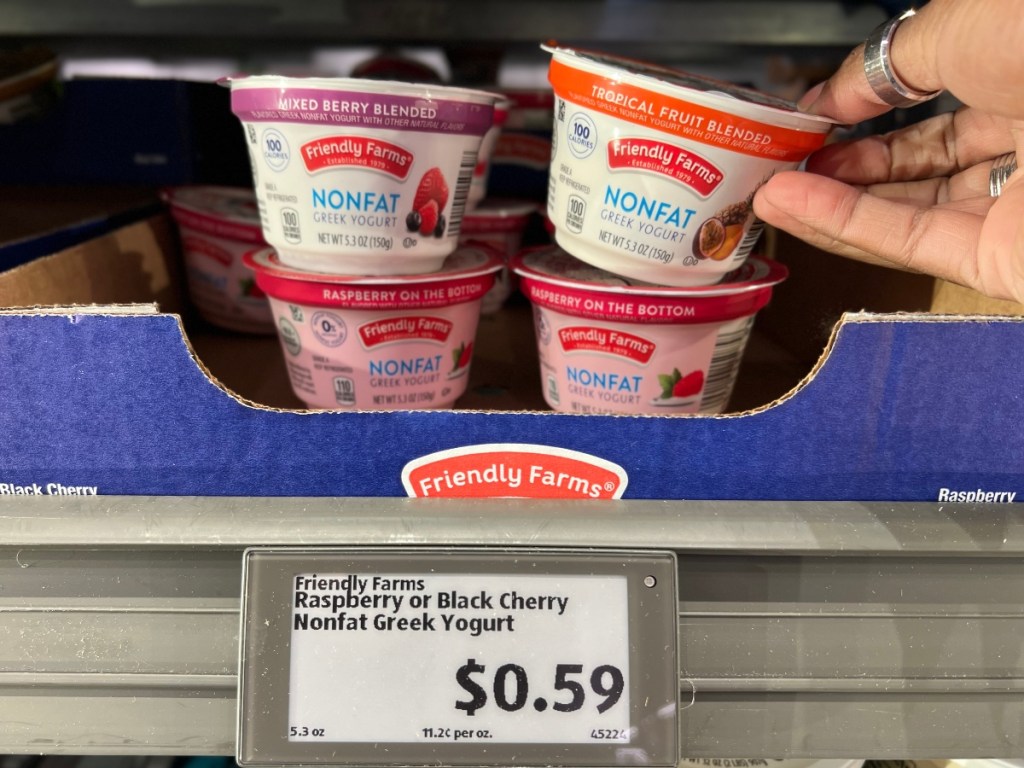 taking greek yogurt off shelf at Aldi