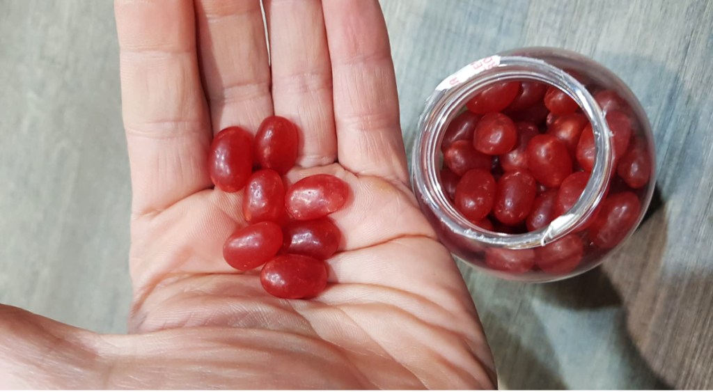 hand holding jelly bean vitamins in palm