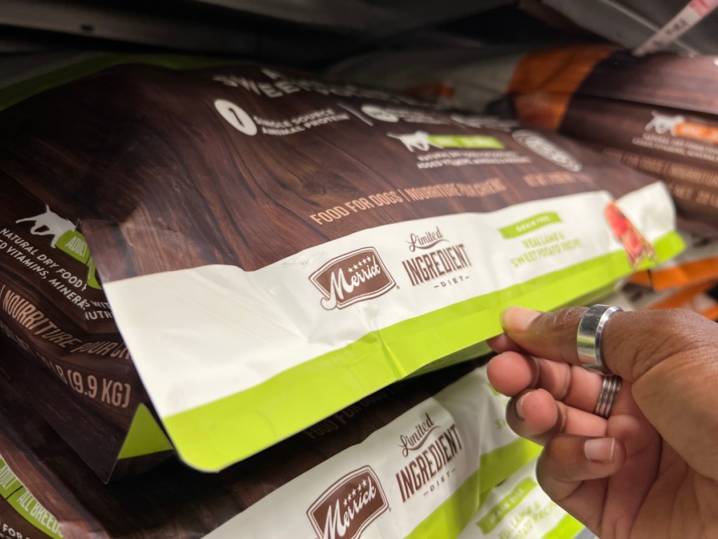 hand grabbing dog food off shelf