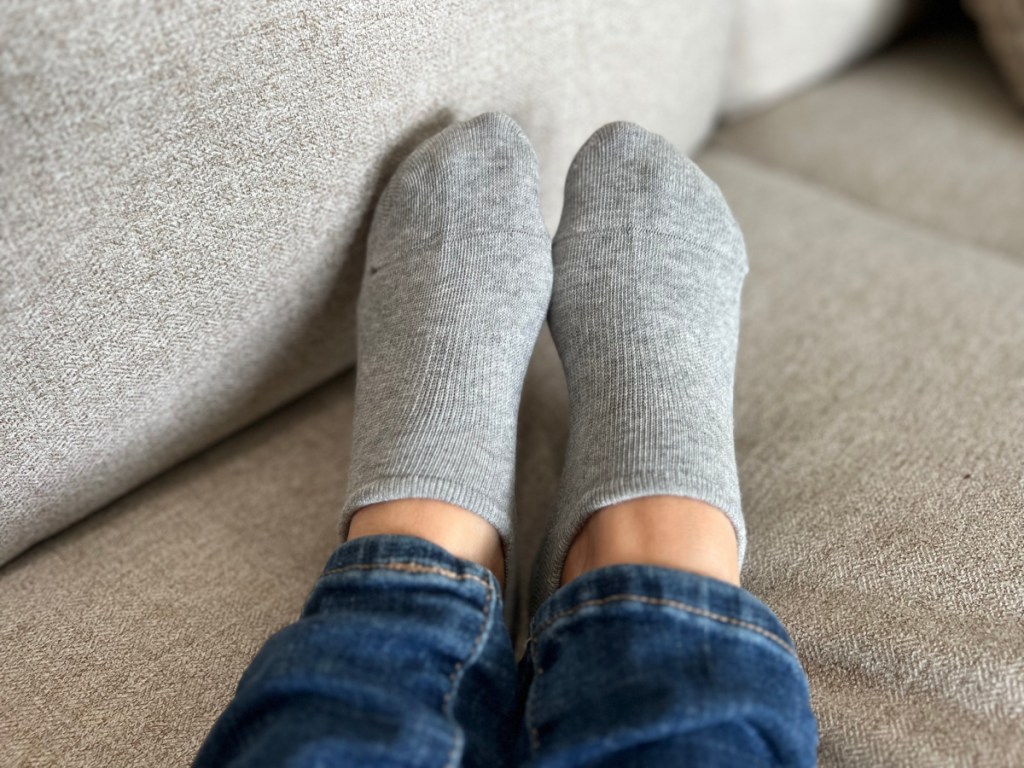 gray no show socks on womans feet wearing jeans