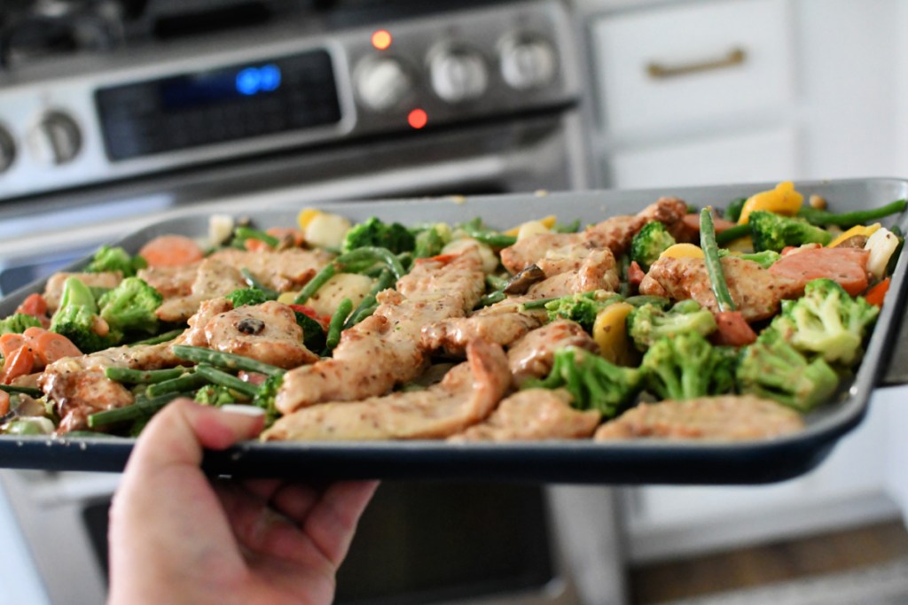 putting sheet pan costco veggies and chicken in the oven