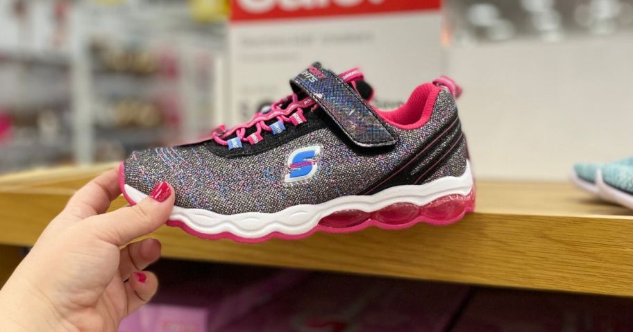 skechers shoe in hand in store