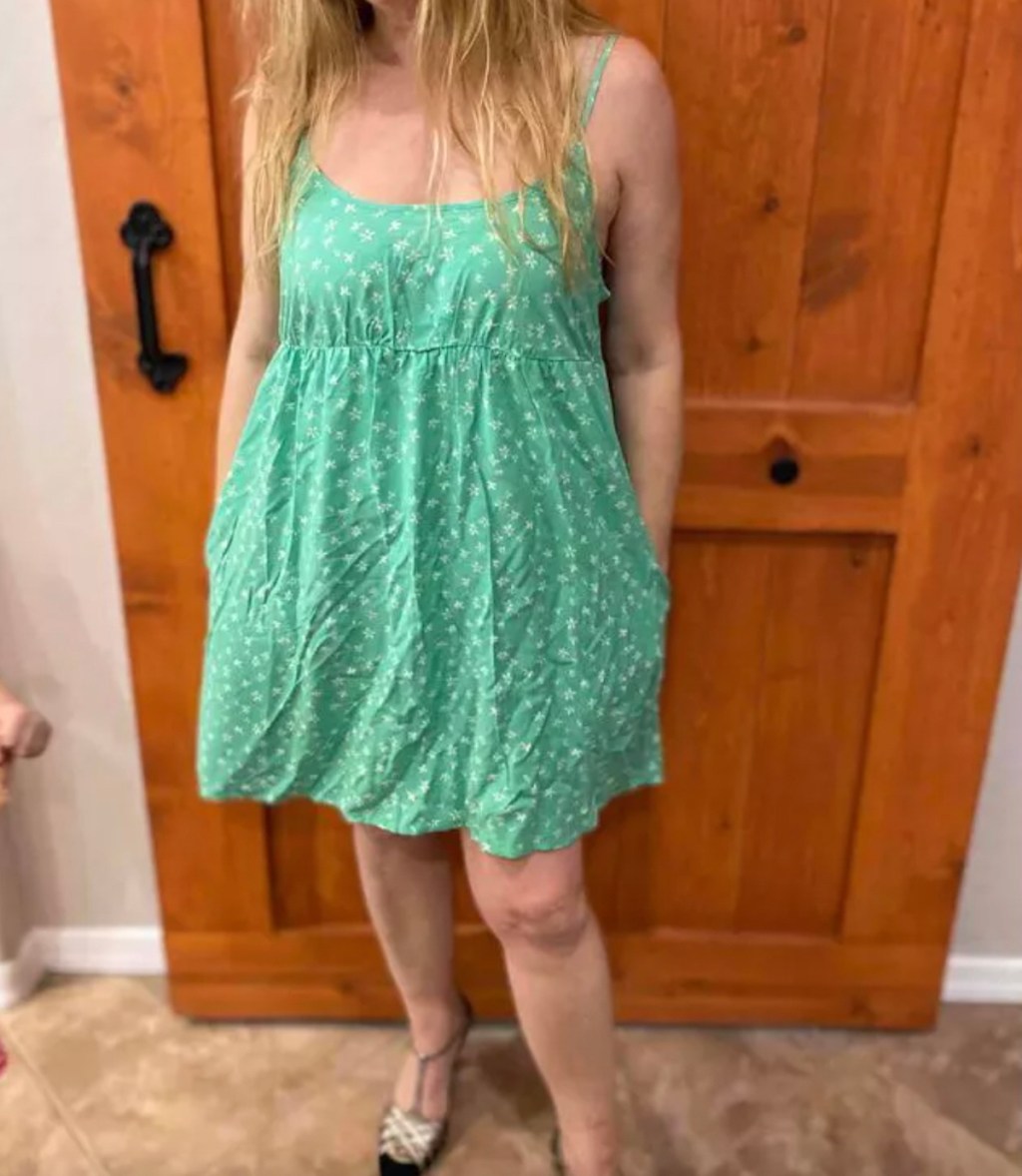 close up of woman wearing summer dresses for women with green and white floral print