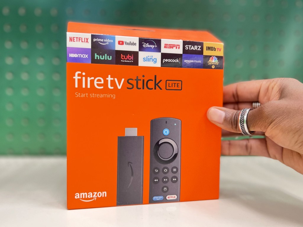 hand holding box to Amazon Fire TV Stick Lite