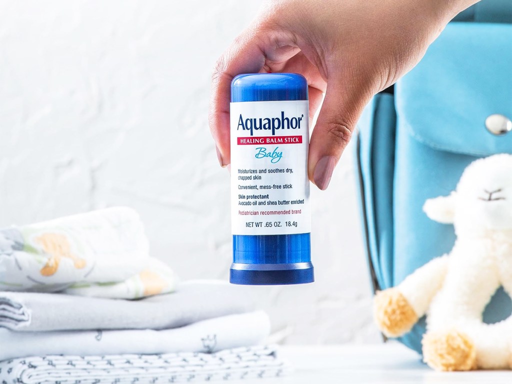 hand holding an Aquaphor Baby Healing Balm Stick