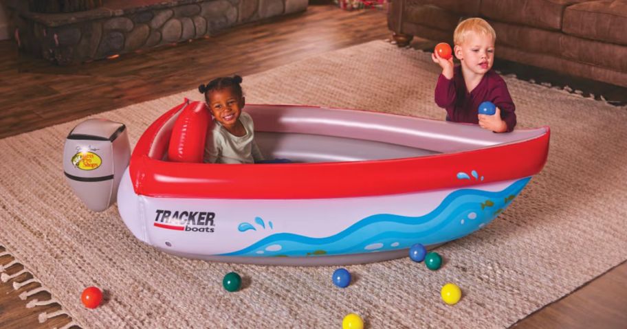 A little girl and boy playing with a Bass Pro Ball Pit