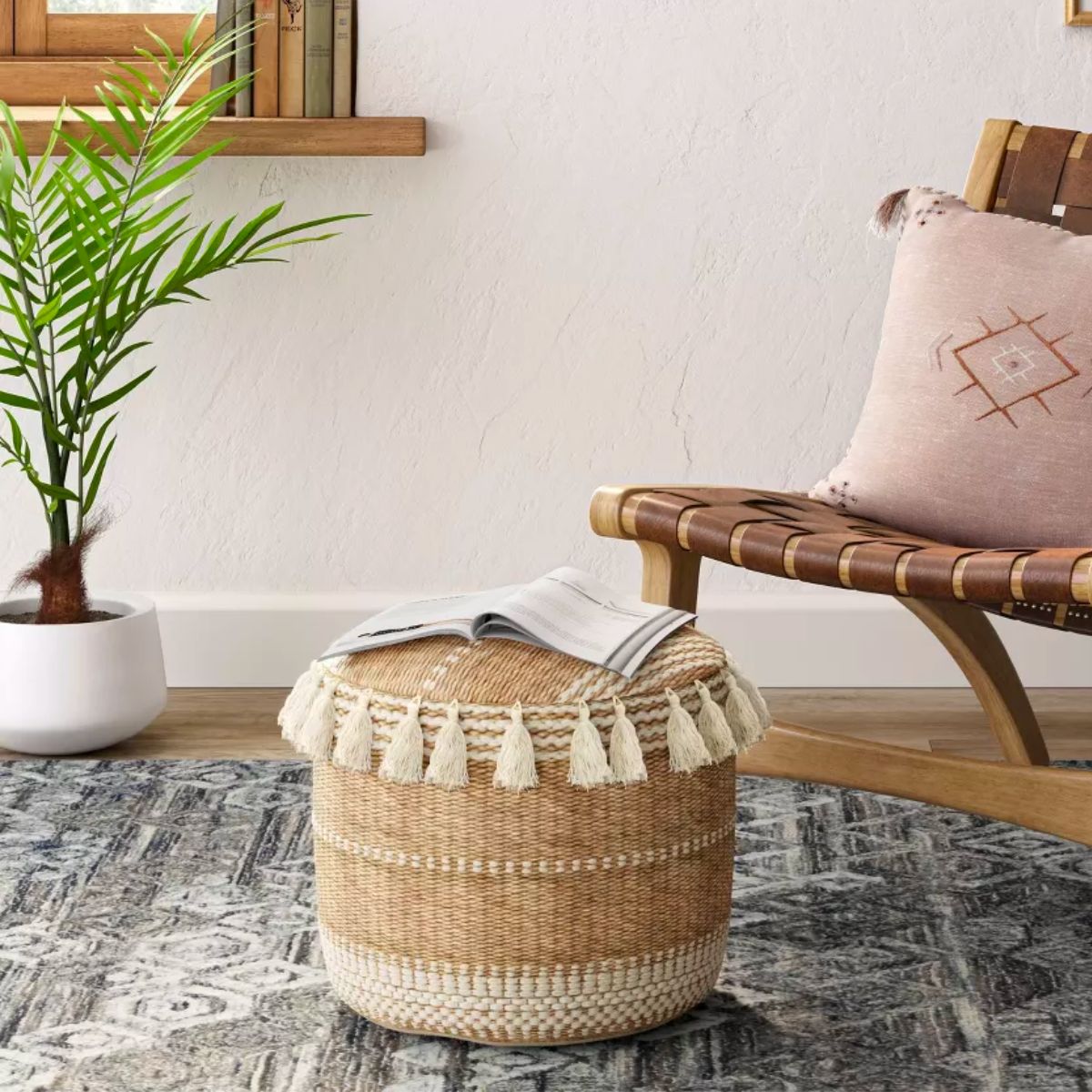 Gemma Pouf Jute Striped/Tassels Natural - by Opalhouse in front of a woven wooden chair