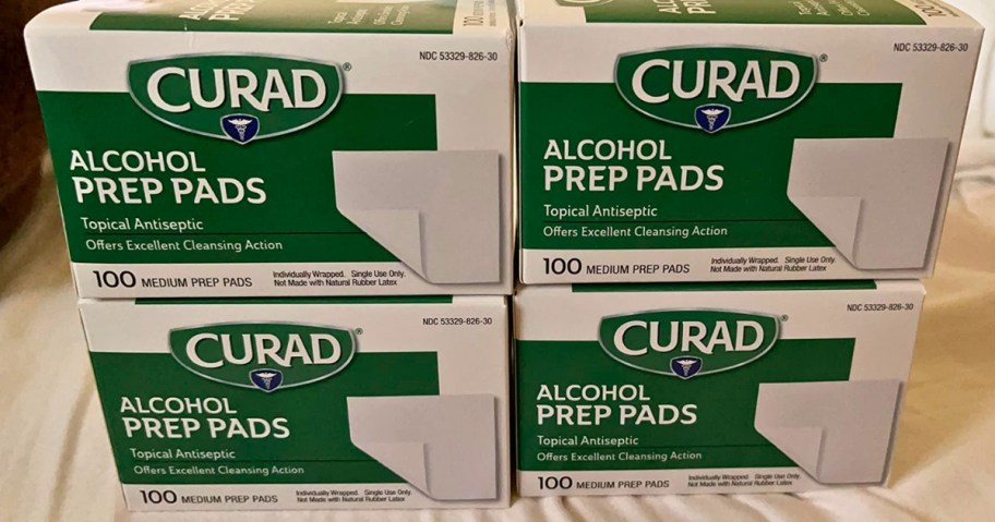 4 green and white boxes of Curad Thick Alcohol Prep Pads stacked