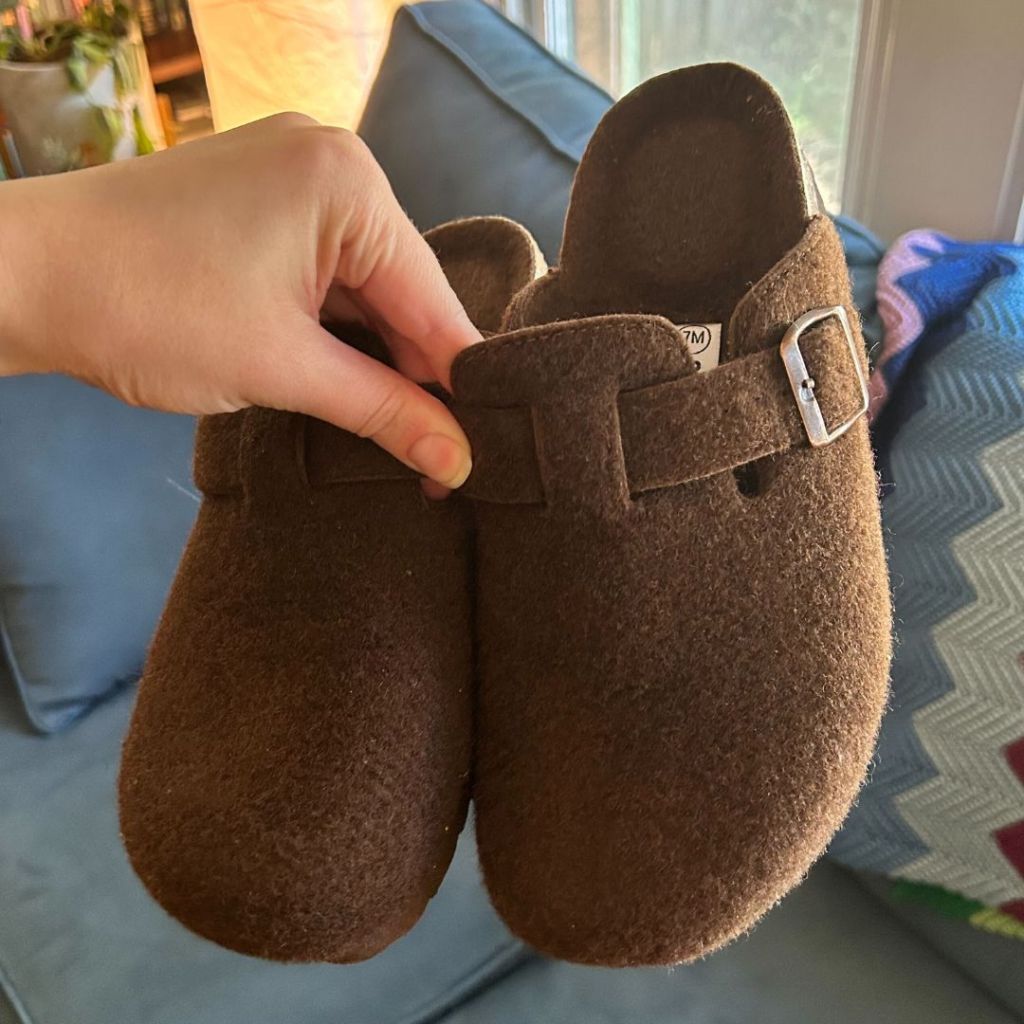 Cushionaire Hana Wool Cork Footbed Clogs in woman's hand