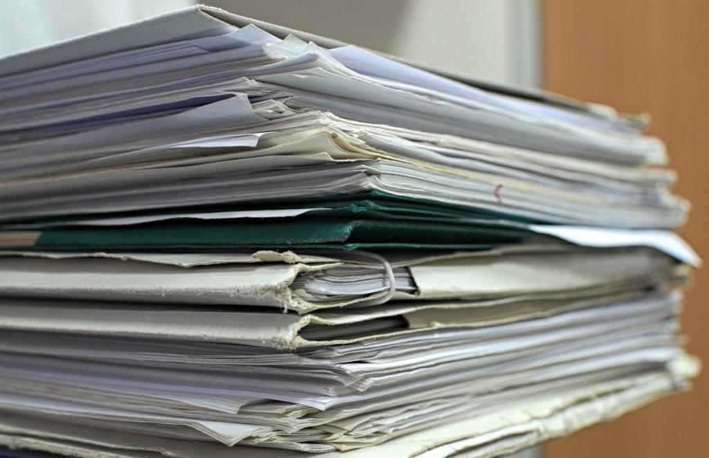 A pile of paperwork being taken to a free shredding event near me