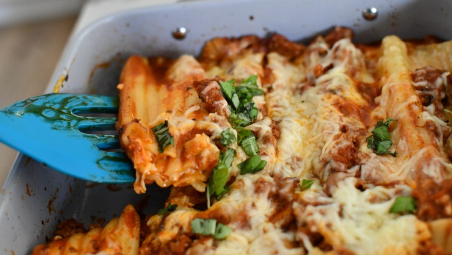 Spatula grabbing a slice of a Stuffed Manicotti with String Cheese recipe