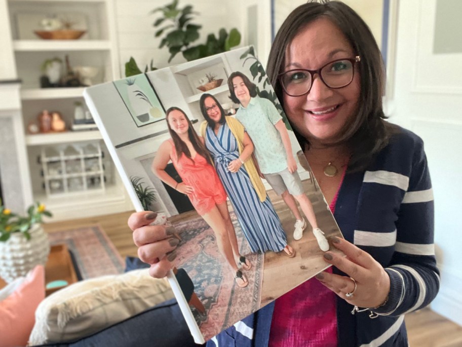 woman smiling and holding photo canvas