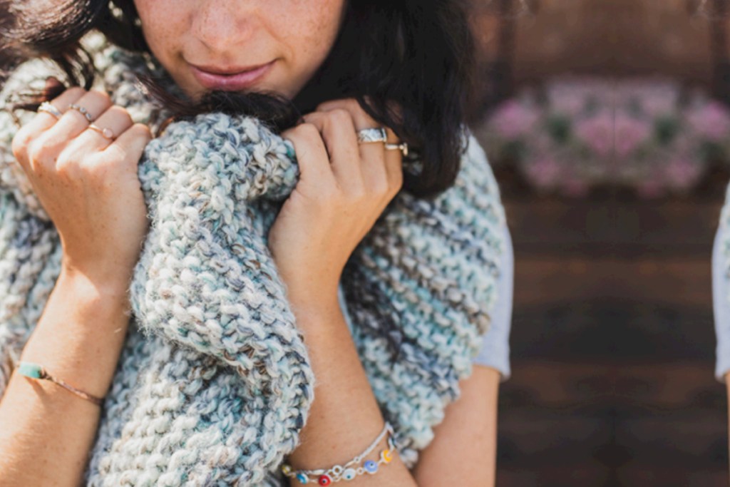 woman holding shawl around neck