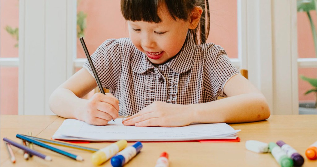 girl coloring on paper