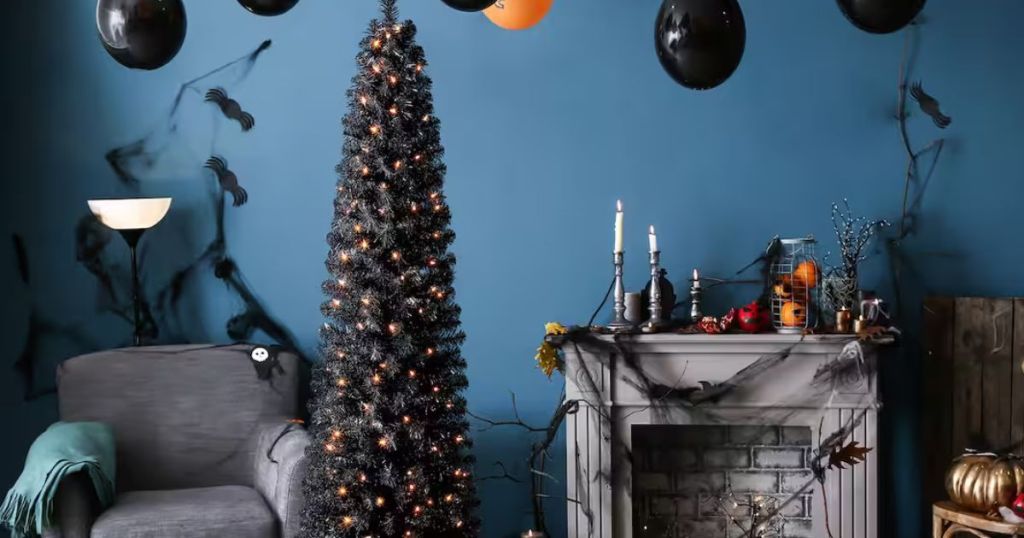 black artificial Halloween tree with orange lights in living room