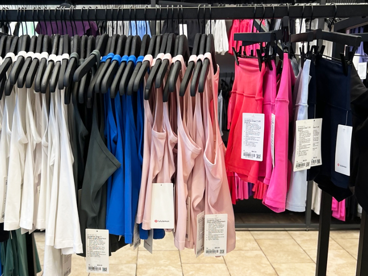 rack of lululemon tank tops and shorts