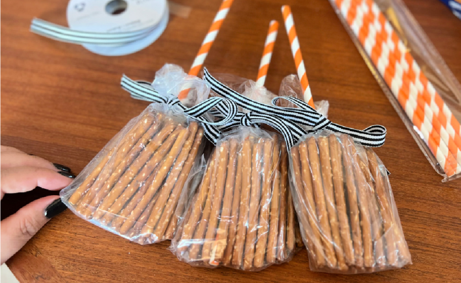 Three witchy pretzel broomsticks which are non candy Halloween treats