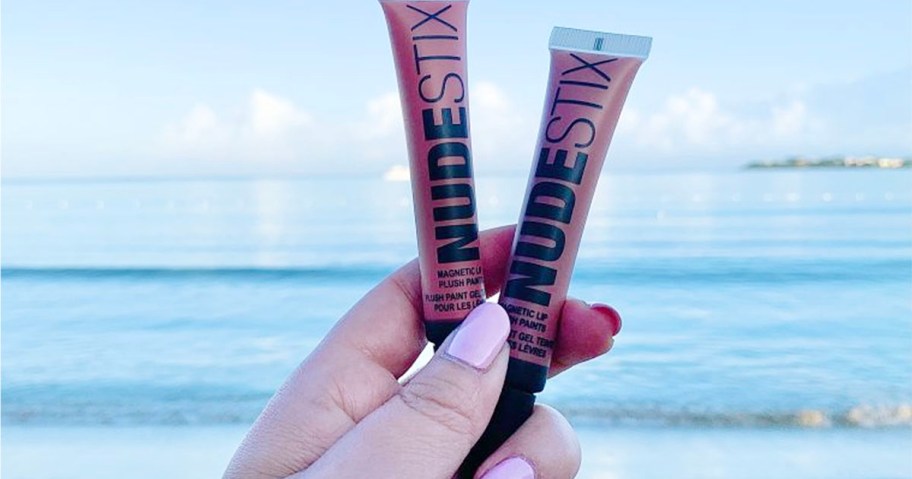 hand holding nudestix lip products