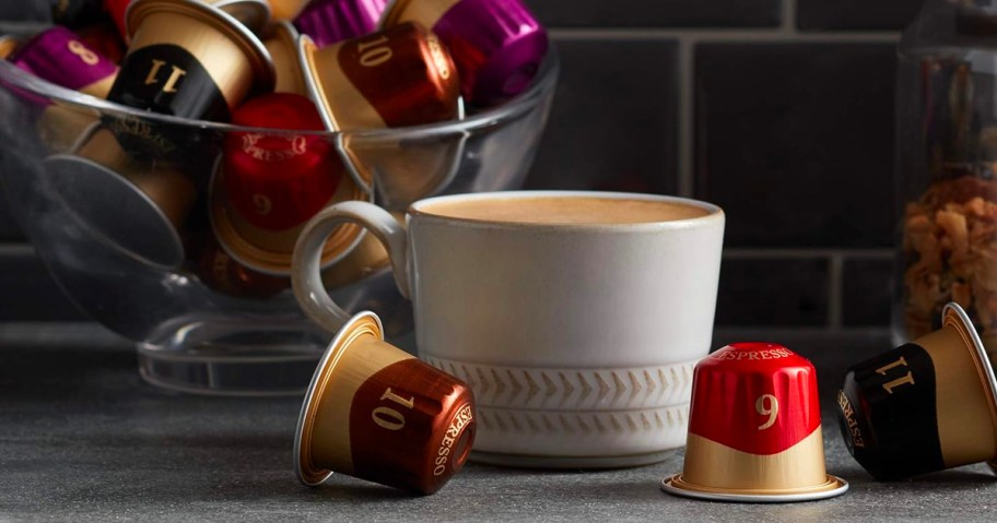 white coffee mug with peets coffee pods laying next to it