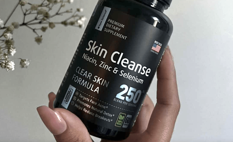 hand holding raw science skin cleanser bottle 