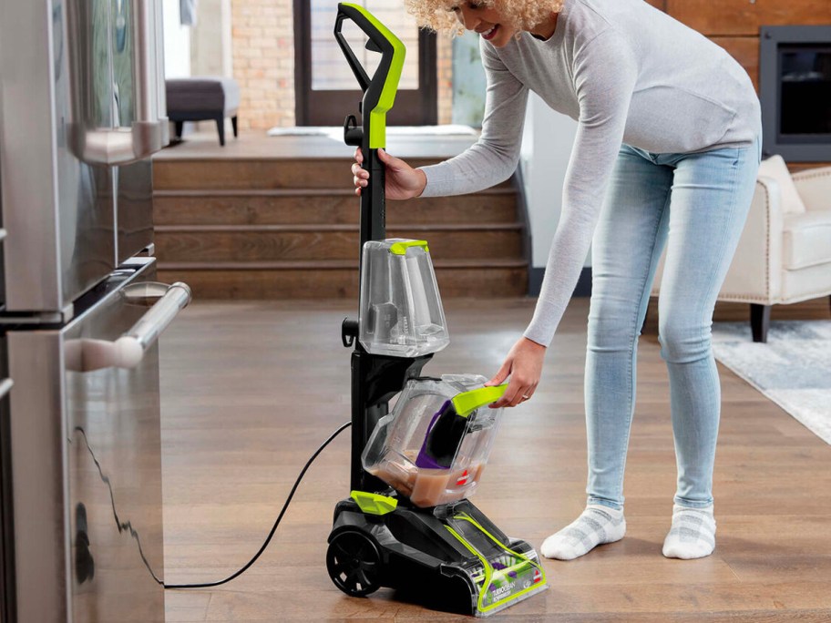 woman cleaning out bissel carpet cleaner