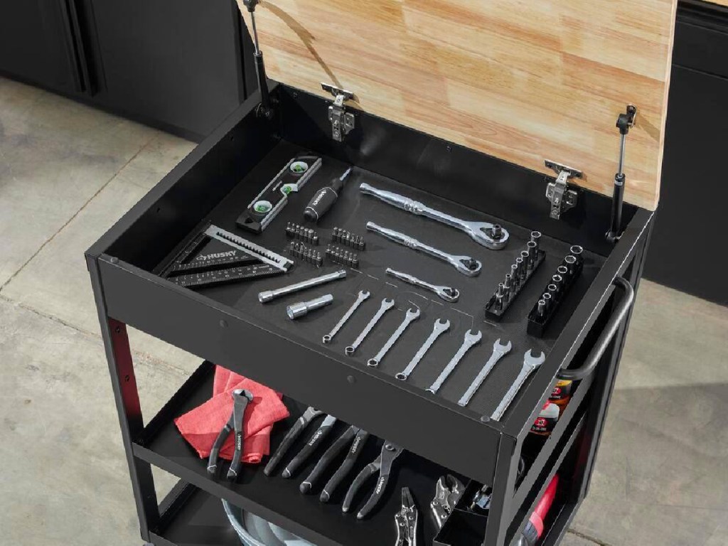 utility cart opened showing all the tools including wrench inside of it