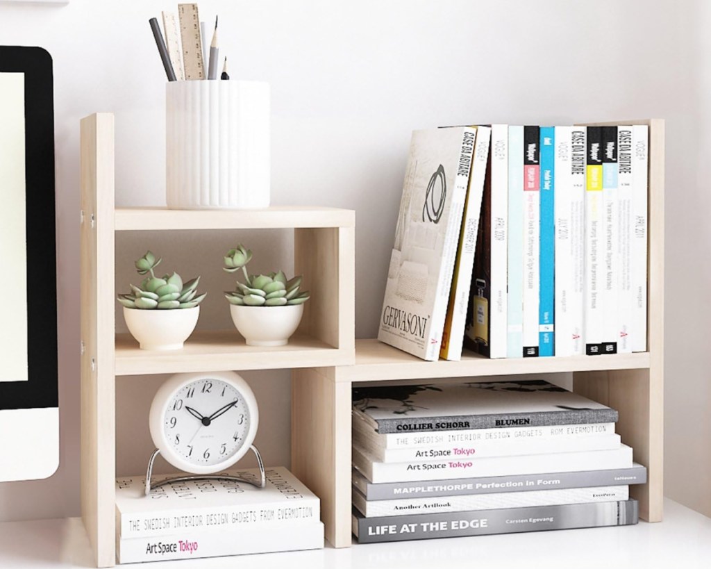 desk organizer with pens and books on it